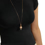Gold pearl pendant necklace with ruby accents, featuring a large pearl encased in a gold chain cage with a smaller pearl drop